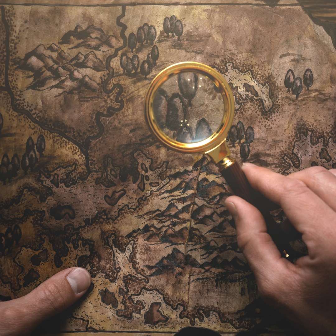 A magnifying glass over a treasure map